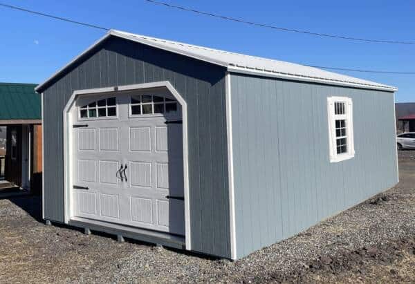 14x24 Smartside A-Frame Garage in blue with white trim, featuring an arched entry door, double windows, and a decorative garage door.