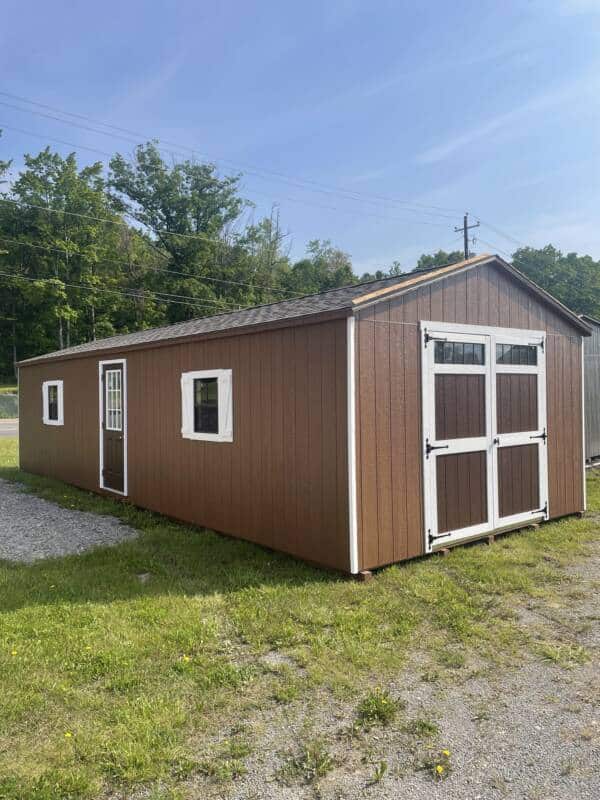14x36 Smartside A-Frame Garage in Chestnut with white trim, Weatherwood roof, brown 9x7 garage door, brown 9 Lite entry door, two brown 24x27 windows with Z shutters, ramps, and loft.