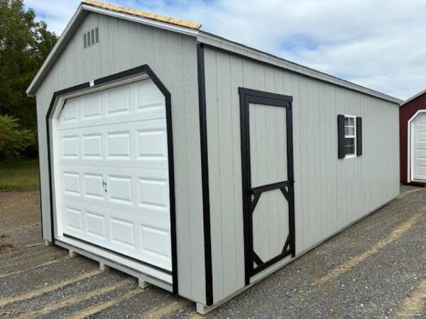 12x24 Smartside A‑Frame garage (Model 2052S) in Gap Gray with black trim and Charcoal Gray architectural shingles; front‑left view showing 9×7 garage door, man door, and 24×27 window with shutters